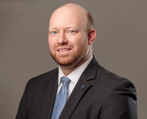AMOS RECEIVES PROMOTION AT FIRST COMMUNITY BANK