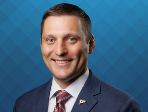 FIRST COMMUNITY BANK PROMOTES MILUM